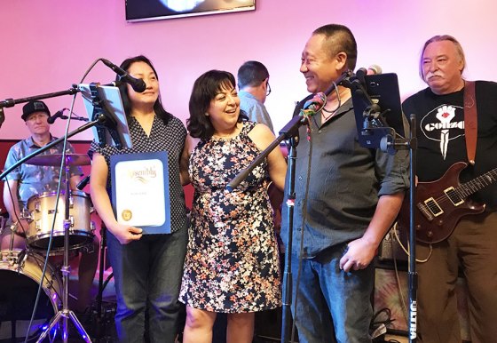 Local representative for Congressman David Valadao, Maria Benitez, presents a proclamation to Sunny and Fanny Law, honoring them on their restaurant's fifth year in business.